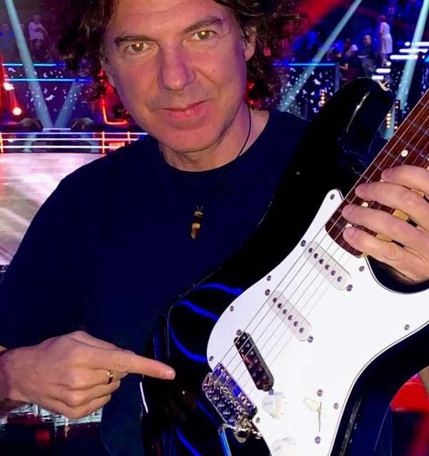 Julian Kanevsky is holding a guitar with VegaTrem tremolo