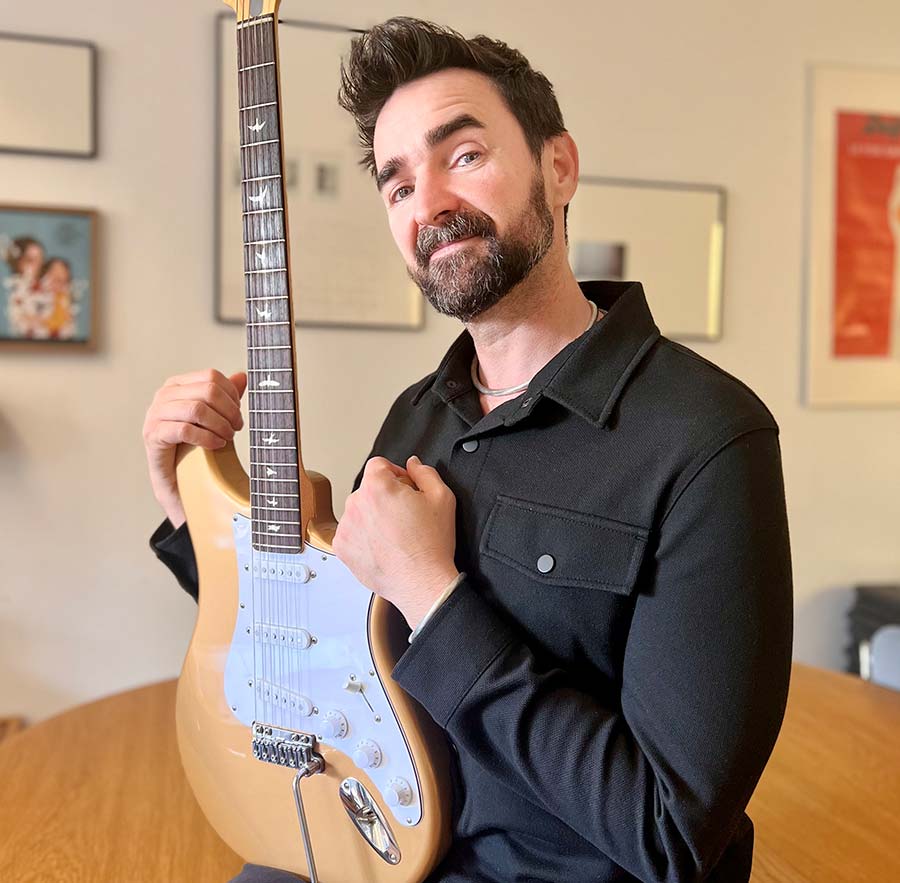 David Palau is holding a guitar with a VegaTrem tremolo
