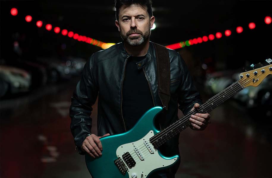 Carlos Asensio with a green guitar and a VT tremolo