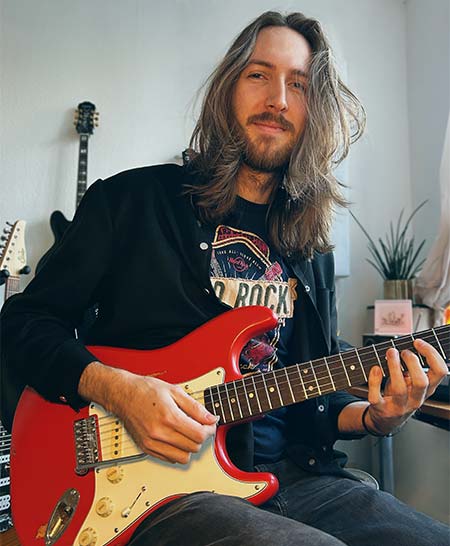 Ricky Ahir guitarist is playing his electric guitar with a VegaTrem Ultratrem in a concert